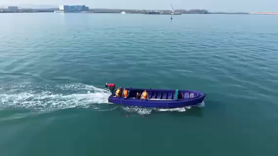 Blue polyethylene boat underway on the water